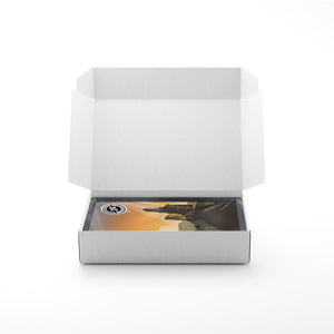 Art print packaging shown inside a protective box, with the print wrapped and secured for shipping