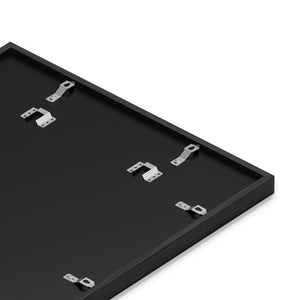 Close-up of metal sawtooth hanging hardware and clips mounted on the back of a framed art print