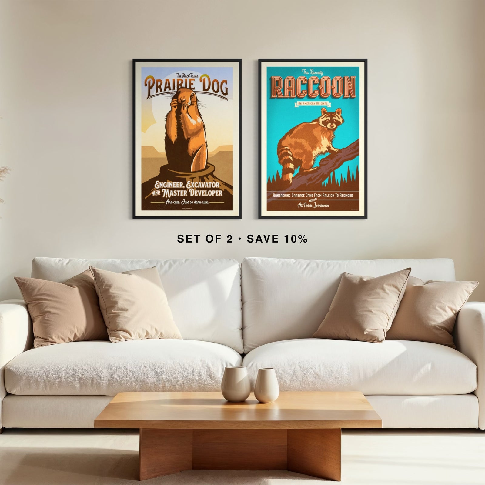 Coordinating prairie dog and raccoon wildlife art prints displayed side by side in frames above a modern couch