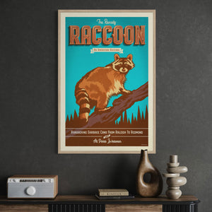 Vintage raccoon wildlife poster presented in a natural oak wood frame in a mid-century office