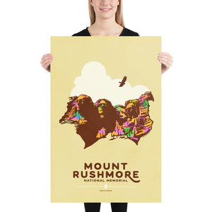 Product mockup of Minimalist giclée art print of Mount Rushmore with four U.S. Presidents and an eagle overhead. Text at the bottom reads "Mount Rushmore National Memorial, South Dakota." Bold colors against a muted background.