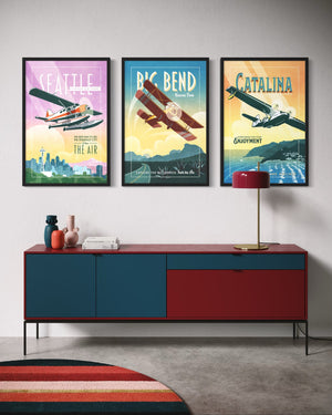 Vintage airplane decor set of three framed travel posters displayed above a modern credenza featuring Seattle seaplane, Big Bend National Park, and Catalina Island artwork