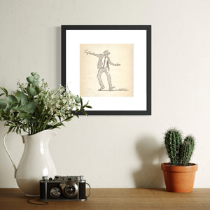  Framed Dancing Man No. 2 digital jazz dancer illustration displayed above a cabinet with a vase, camera, and cactus.