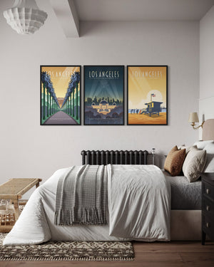 6. Three framed Los Angeles travel posters displayed above a bed, creating a cohesive gallery wall with Hollywood, Griffith Observatory, and Santa Monica themes