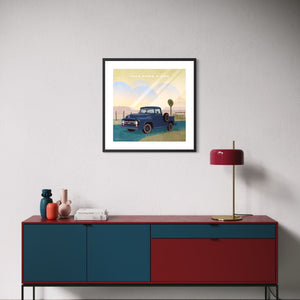 1956 Ford F-100 classic pickup poster displayed above a modern living room credenza in a black frame.