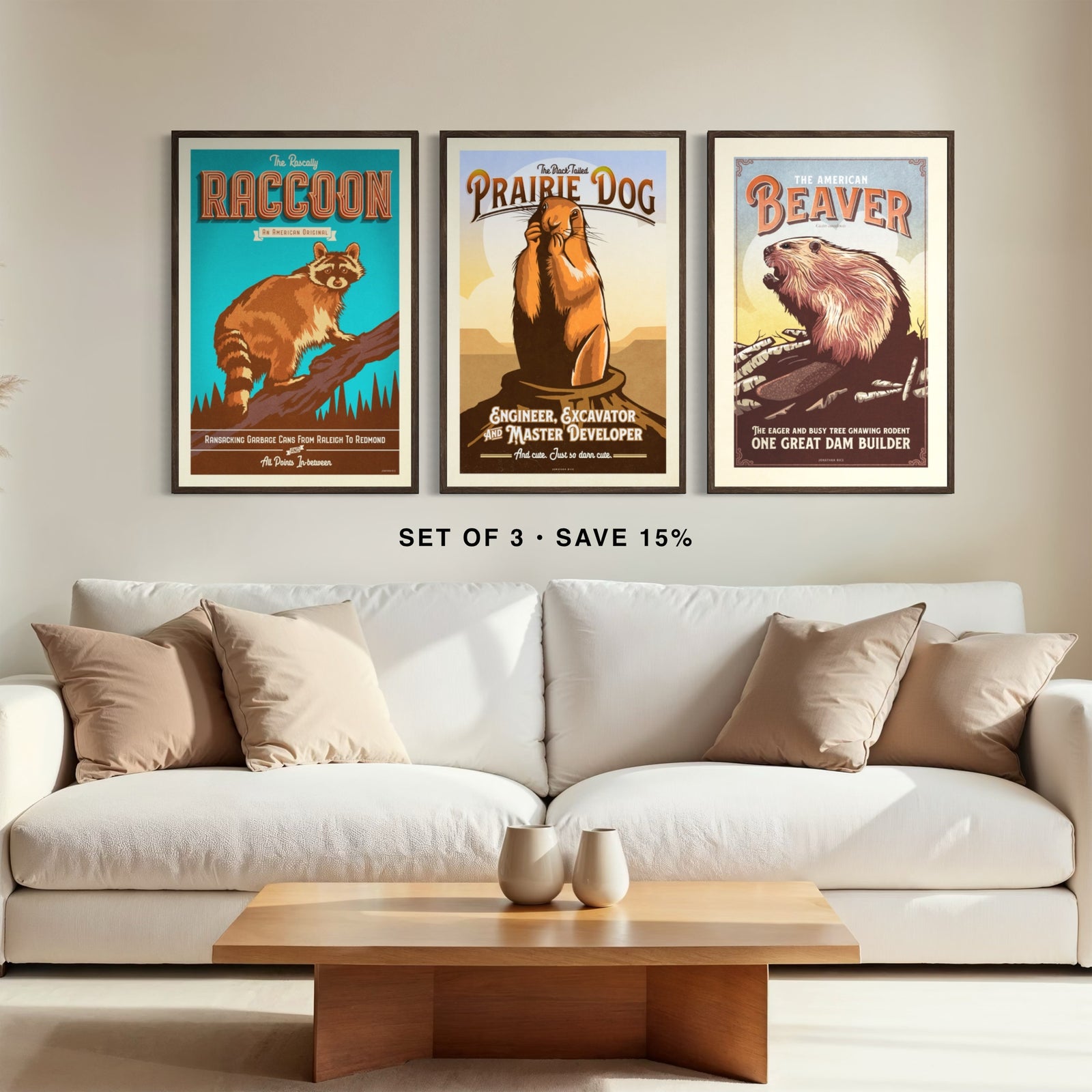 Raccoon, prairie dog and beaver wildlife art prints framed as a gallery set of three above a living room couch