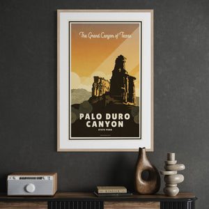 Black framed Palo Duro Canyon State Park travel poster displayed in a contemporary office, adding warm Southwestern character to the workspace.