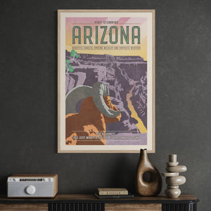 Framed Grand Canyon travel poster displayed in a modern office, featuring a bighorn sheep, dramatic Arizona canyon landscape, and retro Southwest styling.