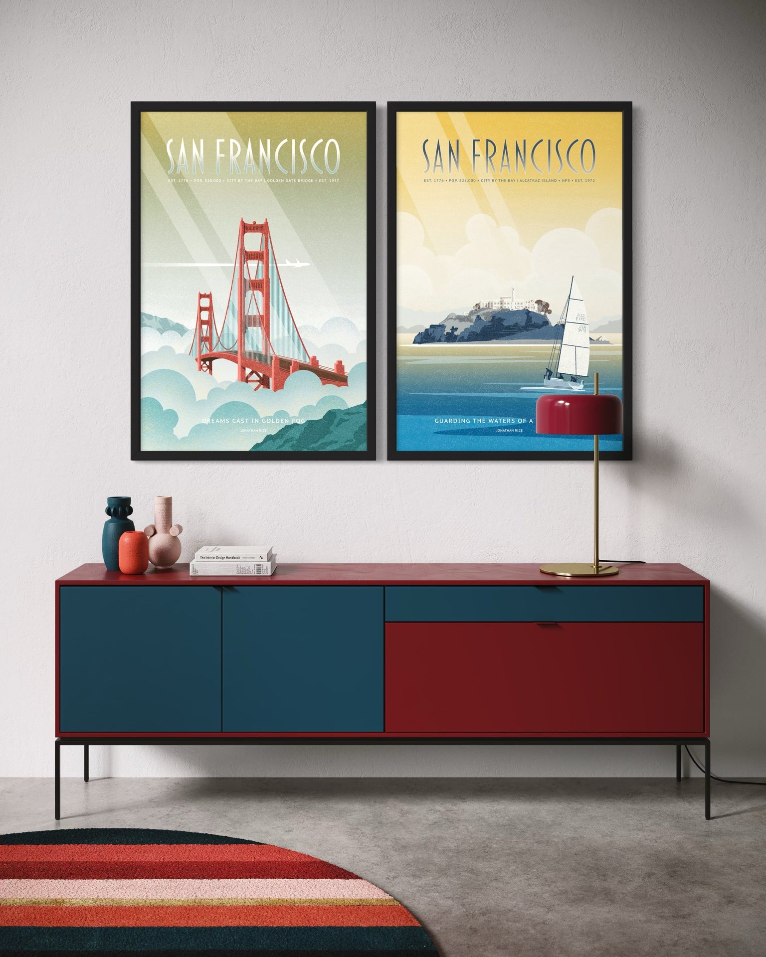 San Francisco gallery set of Golden Gate Bridge and Alcatraz travel posters framed and displayed above a modern credenza