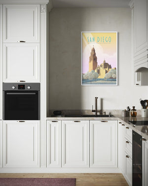 Framed San Diego Balboa Park art print displayed in a modern kitchen interior above a sink and cabinetry