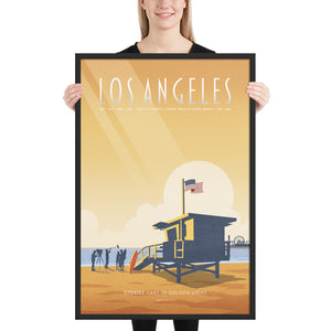 Product mockup of an Illustrated Los Angeles travel poster showing a lifeguard tower, film crew, and Santa Monica Pier at sunset in warm golden tones, retro mid-century design style.