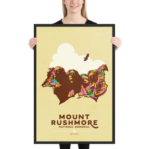 Product mockup of Minimalist giclée art print of Mount Rushmore with four U.S. Presidents and an eagle overhead. Text at the bottom reads "Mount Rushmore National Memorial, South Dakota." Bold colors against a muted background.