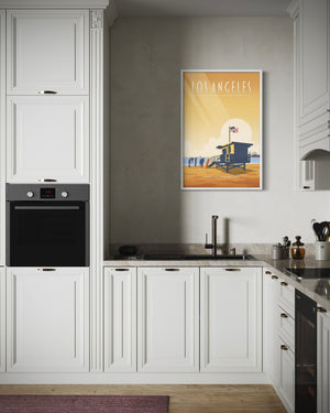 Los Angeles Santa Monica State Beach travel poster displayed in a modern kitchen interior, featuring a lifeguard tower and sunlit coastal scene.