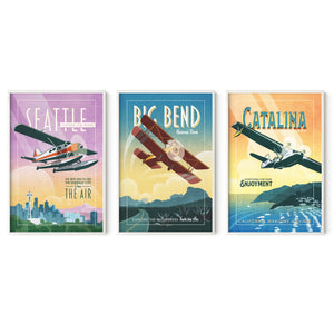 Framed aviation wall art set of three in white wood frames featuring Seattle, Big Bend, and Catalina Island vintage airplane travel posters