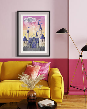 Enchanted castle poster print in black frame, colorful fairy tale wall art above a yellow sofa with pink accents.