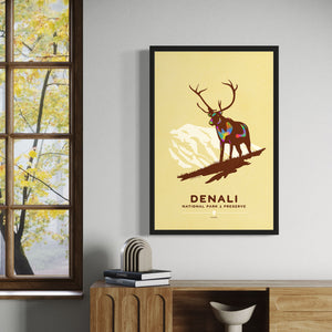 Modern, minimalist giclée art print of Denali National Park & Preserve in Alaska. This simple and classy poster depicts a Caribou standing on a hill top with the mountains in the background.  It has the words “Denali National Park & Preserve, Alaska”  at the bottom. The print’s muted overall background color allows the bold and vibrant colors of the main image to pop. 