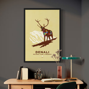 Modern, minimalist giclée art print of Denali National Park & Preserve in Alaska. This simple and classy poster depicts a Caribou standing on a hill top with the mountains in the background.  It has the words “Denali National Park & Preserve, Alaska”  at the bottom. The print’s muted overall background color allows the bold and vibrant colors of the main image to pop. 
