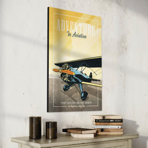 Retro style giclée art print of a modified WACO Biplane ready for takeoff. It has the words “Adventure in Aviaton” at the top. The print’s dusty yellow sunrise colors combined with bright blues and orange of the plane makes for a stunning image. There are additional words a the bottom that says “Sport biplanes for free spirits. Go Anywhere, Any Time.”.
