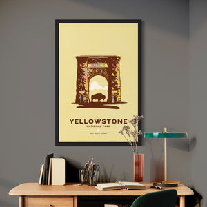 Modern, minimalist giclée art print for Yellowstone National Park in Idaho, Montana and Wyoming. The poster depicts the historic Roosevelt Arch—a gateway to Yellowstone—with a bison standing in the middle of it. It has the words “Yellowstone National Park”  and “Idaho, Montana, Wyoming” at the bottom. The print’s muted overall background color allows the bold and vibrant colors of the main image to pop. 