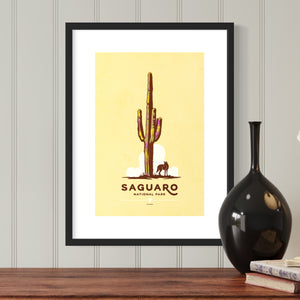 Modern, minimalist giclée art print for Saguaro National Park in Arizona. This simple and classy poster depicts a saguaro cactus with a lone coyote. It has the words “Saguaro National Park, Arizona” at the bottom. The print’s muted overall background color allows the bold and vibrant colors of the main image to pop. 