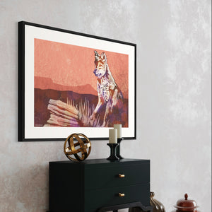 Modern style giclée art print of a Coyote standing on a rock in the wild. With its warm tones, vibrant foreground colors and gritty texture with a minimalist mountainous background.