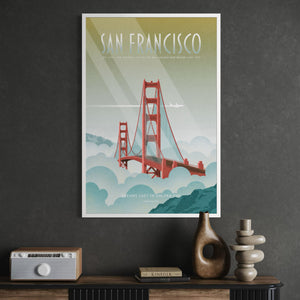 A framed vintage-style travel poster of the Golden Gate Bridge in San Francisco hangs on a dark textured wall above a console table with decorative objects.