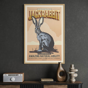 Framed poster of a jackrabbit on a dark wall above a wooden cabinet from the Creatures of Character animal illustration series.