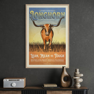 Natural oak framed poster of The Texas Longhorn poster by Jonathan Rice above a retro inpired cabinet.