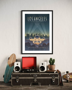 Los Angeles Griffith Observatory travel poster displayed above a record player setup with speakers, vinyl records, cactus plant, and a skateboard leaning against the wall.