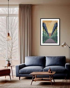 Los Angeles “Boulevards of Palms and Dreams” poster displayed above a modern sofa in a warm, mid-century living room.
