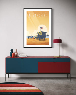 Los Angeles Santa Monica Beach art print framed above a modern credenza with red and blue accents in a stylish room.
