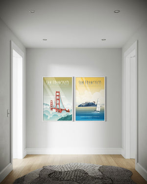 Two framed posters of San Francisco on a wall in a hallway..