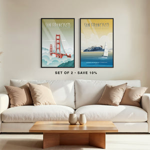 Living room with a white sofa, wooden coffee table, and two framed 'San Francisco' posters on the wall.