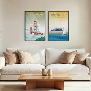 San Francisco travel poster set with Golden Gate Bridge and Alcatraz wall art above couch in a living room.