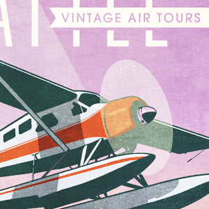 Detail of Retro style giclée art print of a De Havilland Canada DHC-2 Beaver floatplane flying over Seattle, Washington.. It has the words “Seattle Vintage Air Tours” at the top. The print’s soft purples, yellows, blues and greens create a stunning backdrop for the classic floatplane with it’s touch of red. There are additional words a the bottom that says “The best way to see the Emerald City is from the air.”