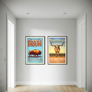 Walnut framed Bison and Longhorn animal prints displayed together in a hallway gallery wall setting