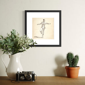 Framed Dancing Man No. 1 digital pen-and-ink illustration displayed above a cabinet with a vase, camera, and cactus. 