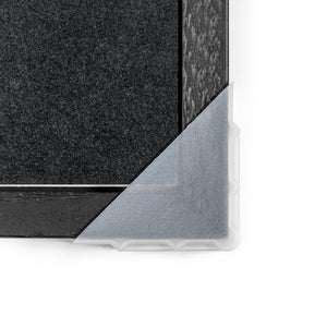 Close up of a plastic protective corner covering a wood frame.