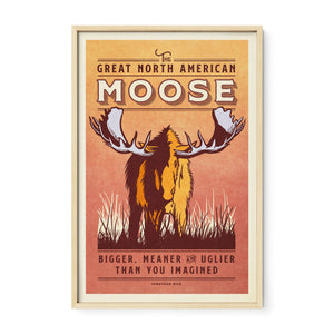 Oak framed moose wildlife print with warm natural wood tones that complement the earthy colors of the vintage animal illustration.