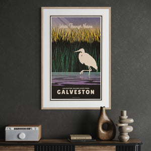 Framed Galveston Island State Park Texas travel poster featuring a white egret and coastal marsh landscape displayed in an office.