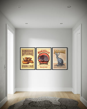 Set of three framed animal posters displayed in a hallway featuring rattlesnake, armadillo, and jackrabbit artwork