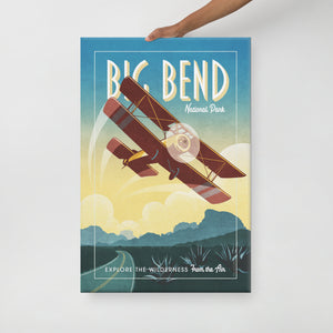 Retro style giclée art print of Sopwith Pup Biplane flying over Big Bend National Park in Texas. It has the words “Big Bend National Park” at the top. The print dusty blues, teals combined with bright sunset colors. There are additional words a the bottom that says “Explore the Wilderness from the Air”. Canvas Wrap size: 24" x 36"