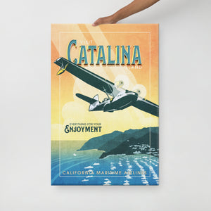 Retro style giclée art print of a PBY Catalina Flying Boat Aircraft flying over Catalina Island, California. It has the words “Visit Catalina Island” at the top. The print’s cool blues and greens combined with the warm sunset sky creates a stunning backdrop for the classic flying boat with bright cool color and yellow highlights. There are additional words a the bottom that says “Everything for your Enjoyment. California Maritime Airlines.” Canvas wrap size 24" x 36"