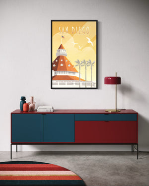 Framed San Diego Hotel del Coronado travel poster displayed above colorful credenza in modern home interior
