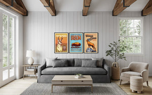 Set of three vintage-style Western animal posters featuring pronghorn, bison, and bighorn sheep displayed above a living room sofa