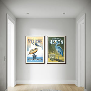 Brown Pelican and Blue Heron framed coastal bird prints displayed together in a hallway
