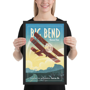 Retro style giclée art print of Sopwith Pup Biplane flying over Big Bend National Park in Texas. It has the words “Big Bend National Park” at the top. The print dusty blues, teals combined with bright sunset colors. There are additional words a the bottom that says “Explore the Wilderness from the Air”. Framed size: 12" x 18"