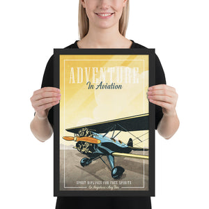 Retro style giclée art print of a modified WACO Biplane ready for takeoff. It has the words “Adventure in Aviaton” at the top. The print’s dusty yellow sunrise colors combined with bright blues and orange of the plane makes for a stunning image. There are additional words a the bottom that says “Sport biplanes for free spirits. Go Anywhere, Any Time.” Framed size 12" x 18"
