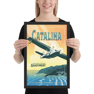 Retro style giclée art print of a PBY Catalina Flying Boat Aircraft flying over Catalina Island, California. It has the words “Visit Catalina Island” at the top. The print’s cool blues and greens combined with the warm sunset sky creates a stunning backdrop for the classic flying boat with bright cool color and yellow highlights. There are additional words a the bottom that says “Everything for your Enjoyment. California Maritime Airlines.” Framed size 12" x 18"