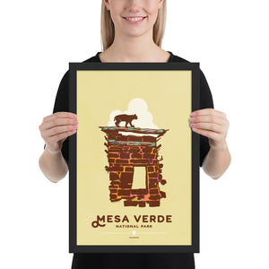 Modern, minimalist giclée art print for Mesa Verde National Park in Colorado. This simple and classy poster depicts a section of the ruins of Mesa Verde with a bobcat walking across the top of it.  It has the words “Mesa Verde National Park, Colorado” at the bottom. The print’s muted overall background color allows the bold and vibrant colors of the main image to pop.  Framed print size 12" x 18"